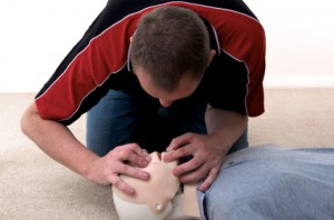 Man administering CPR to dummy